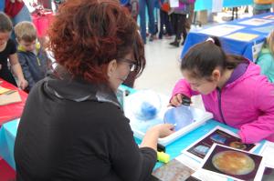 Photo of facilitator and learner looking into ice sphere 