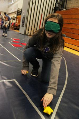 Learner blindfolded and being guided during Mars rover activity