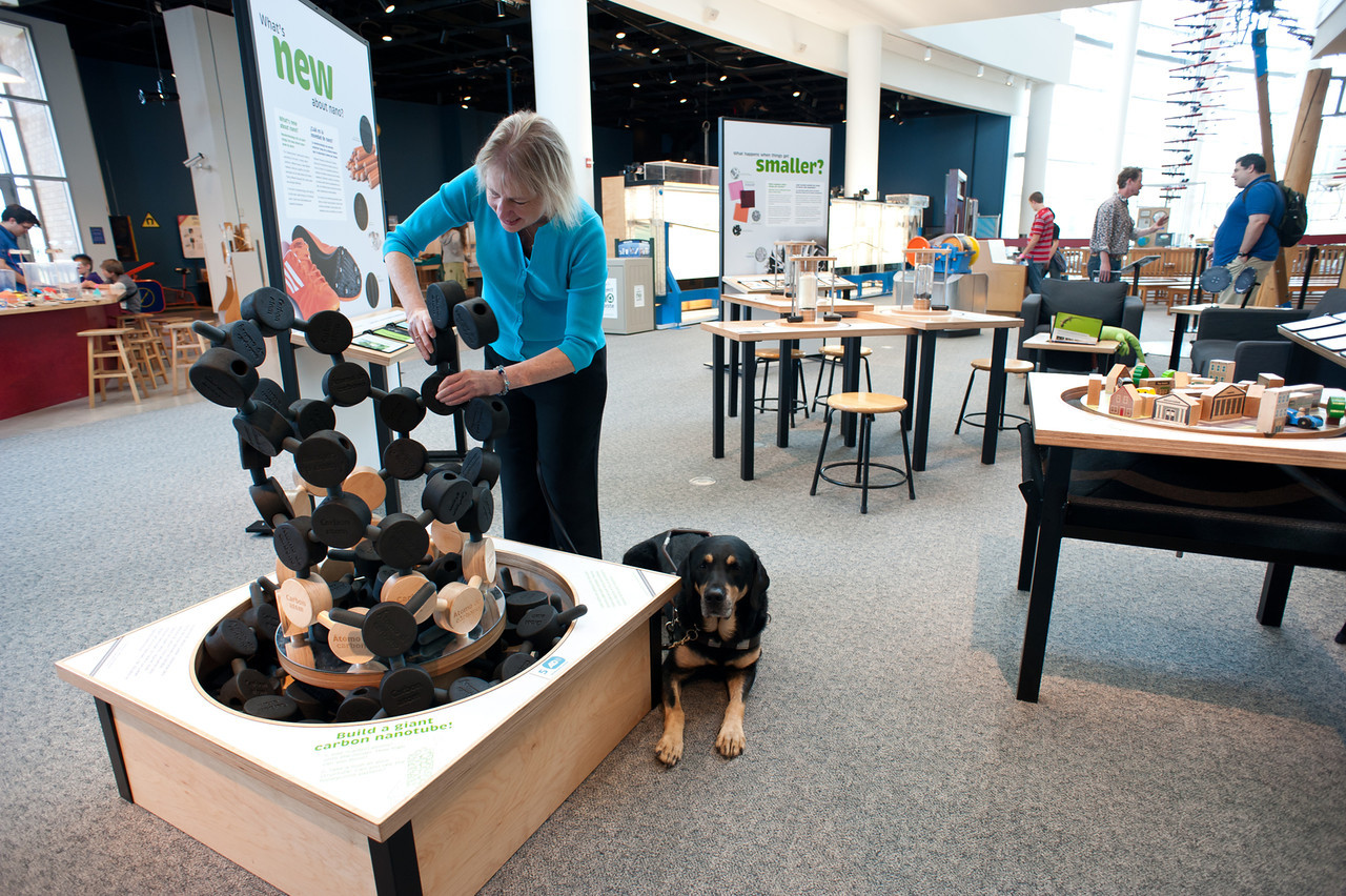 A visitor and service dog at the mini-exhibition