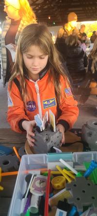 LVCM Under the Start event - girl in NASA jumpsuit with activity