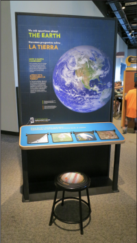 Single exhibition component, there is a large graphic that says The Earth with a large image of the Earth showing North America.