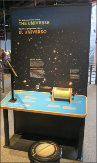 Single exhibition component, there is a large graphic that says The Universe with an image from the Hubble Telescope of galaxies in darkness.