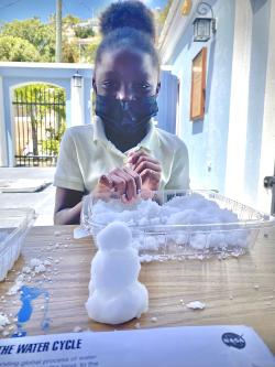 Young learner experimenting with "instant snow" material
