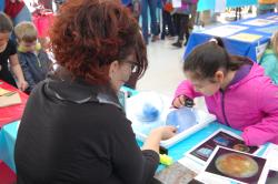 Photo of facilitator and learner looking into ice sphere 