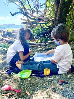 Image of young learners with beach in background