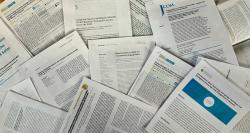 Publications and published papers from the NISE Network projects printed and arranged in a pile