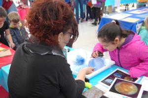 Photo of facilitator and learner looking into ice sphere