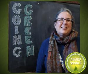 Photo of an Gaithersburg Museum educator accepting a going green award