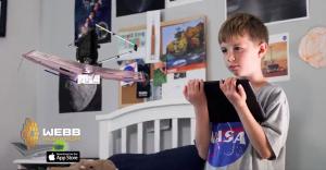NASA Webb Space Telescope Augmented Reality App child with iPad looking at floating model