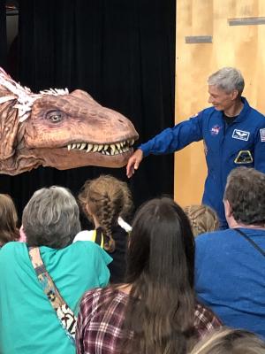 NASA Astronaut Mark Vande Hei at Science Museum of Minnesota 2019 Moon Landing anniversary event with giant dinoaur T-Rex puppet 