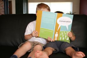 Two Kids holding Conversation book - Photo credit Kris Hoet