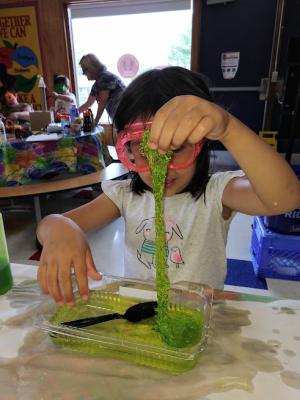 Maine Discovery Museum young child with slime created from a Discovery Kit