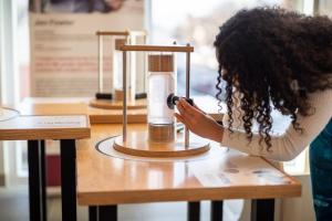 A visitor exploring ferrofluid in the the Nano exhibition at the Missoula Public Library