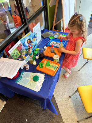 Early Explorers Activity Table with Young Girl Engaged with a Water Dropper