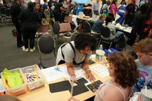 NASA Langley Research Center Open House MLS - Table Activity with Facilitator Working with Two Young Participants