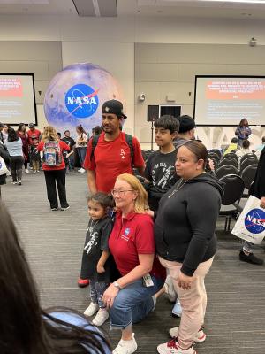 NASA Langley Research Center Open House-Families Visiting Pose for Photo in Front of NASA Logo