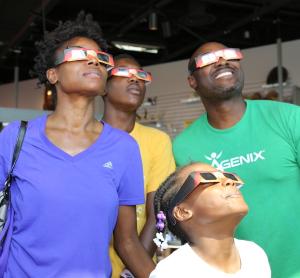 Family using safe solar viewing glasses