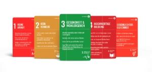 Five Cards from the Card for Humanity game appear in five difference colors - shades of red, orange, and green
