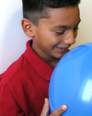 Child smelling balloon using Exploring Size - Scented Balloons NanoDays 