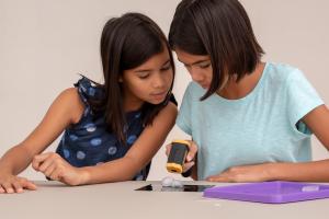 Children measure temperatures using a tool