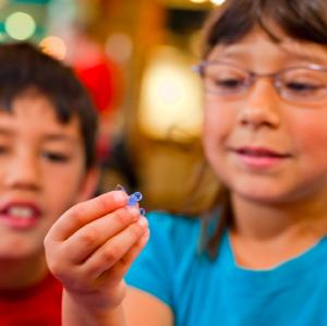 Photo of learners holding and examining gummy capsule creation