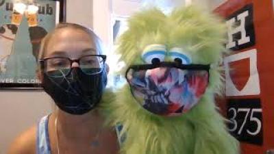 Educator with a green puppet