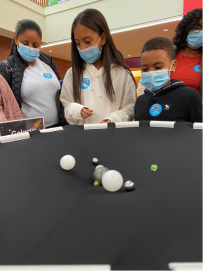 Visitors using Orbiting Objects activity at Webb Space Telescope Event photo courtesy of Marbles Kids Museum