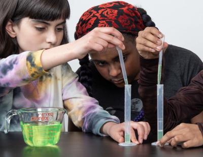 Voyage through the Solar System Breath of Fresh Air activity with children measuring liquid droppers with graduated cylinders