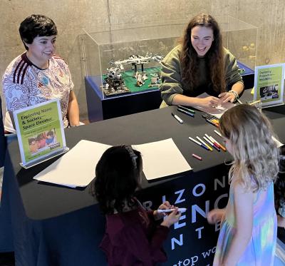 ASU NanoDays activities at Arizona Science Center October 2023 talking with visitors at a table