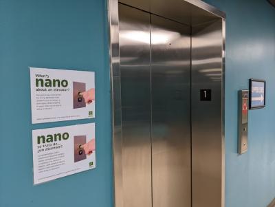 Greensboro Science Center Nano exhibition 2023 Nano graphic signs next to elevator
