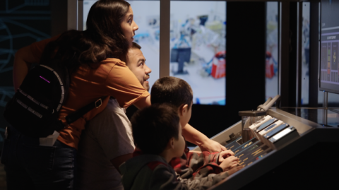 Family interacting together with Mission Future exhibition