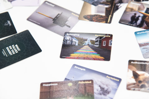 Colorful cards lay scattered on a white table cloth.