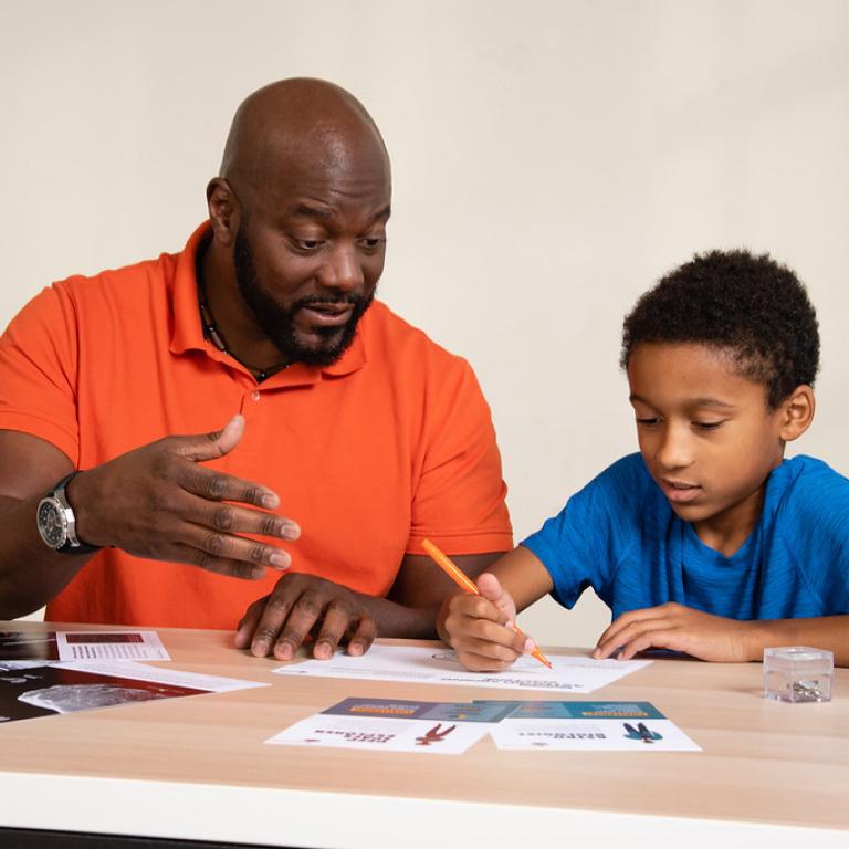 Dad and child talking and creatively drawing using Asteroid Mining Earth and Space activity 