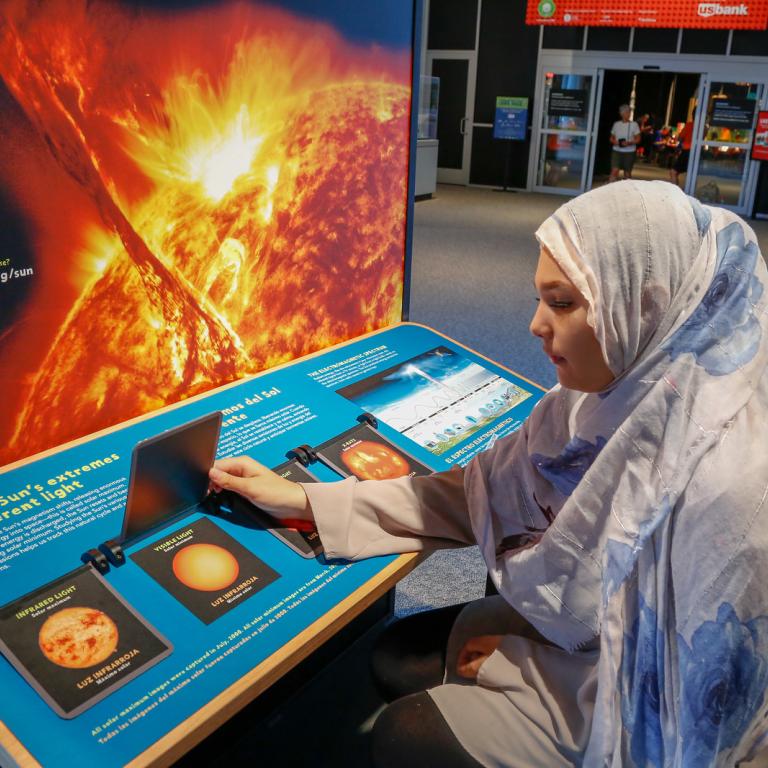 Sun Earth Universe visitors using Sun exhibit flip doors