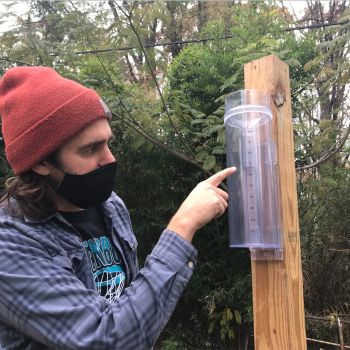 Citizen scientist taking a precipitation measurement on a CoCoRaHS rain gauge