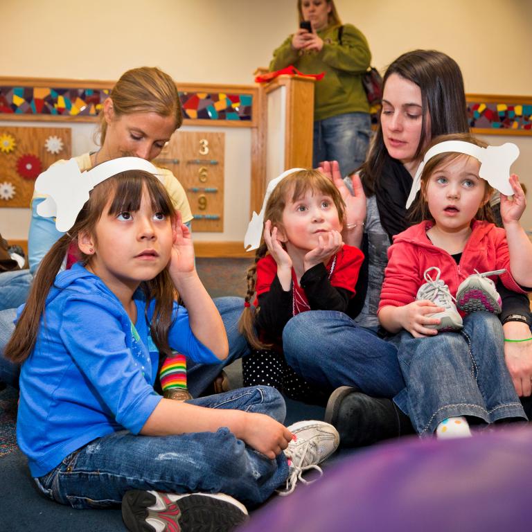 Children listening wearing paper elephant ears in Horton Senses Something Small NanoDays activity