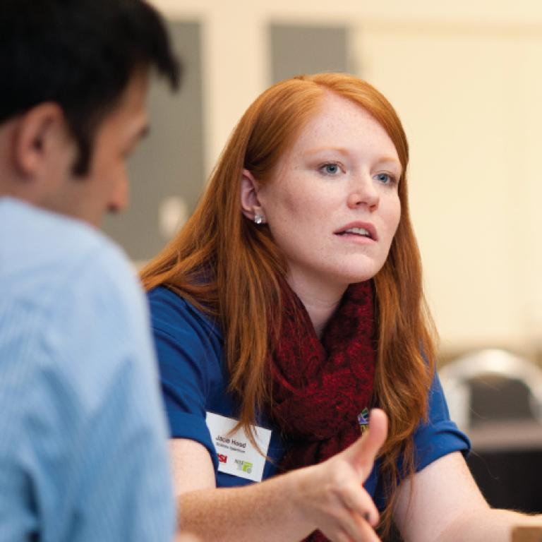 Professional talking at a conference 