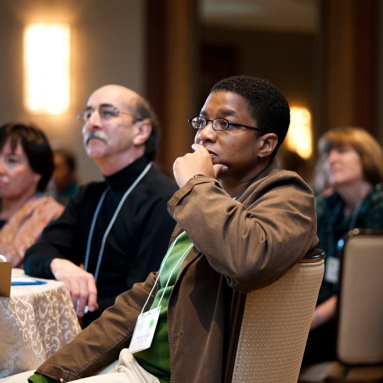 Professionals listening at a meeting 