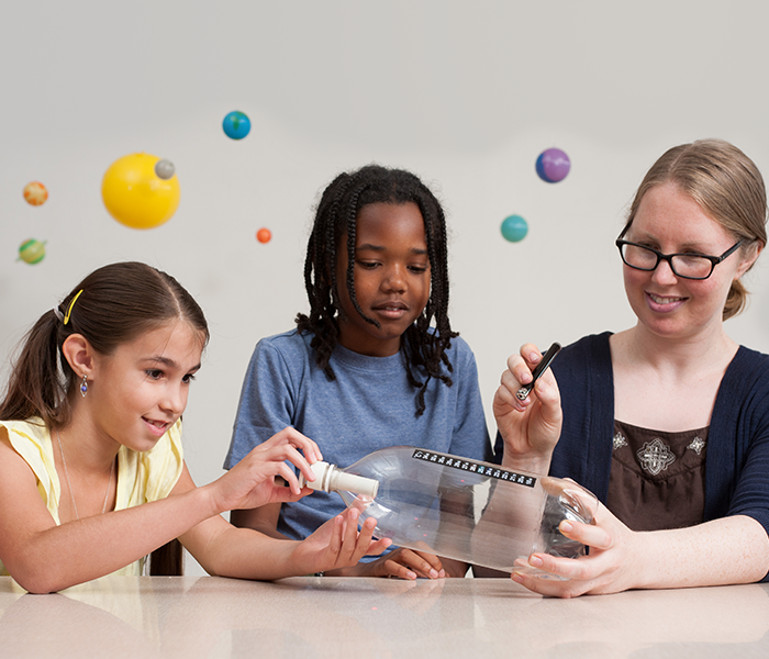 Children and scientist exploring air in a bottle in Investigating Clouds activity