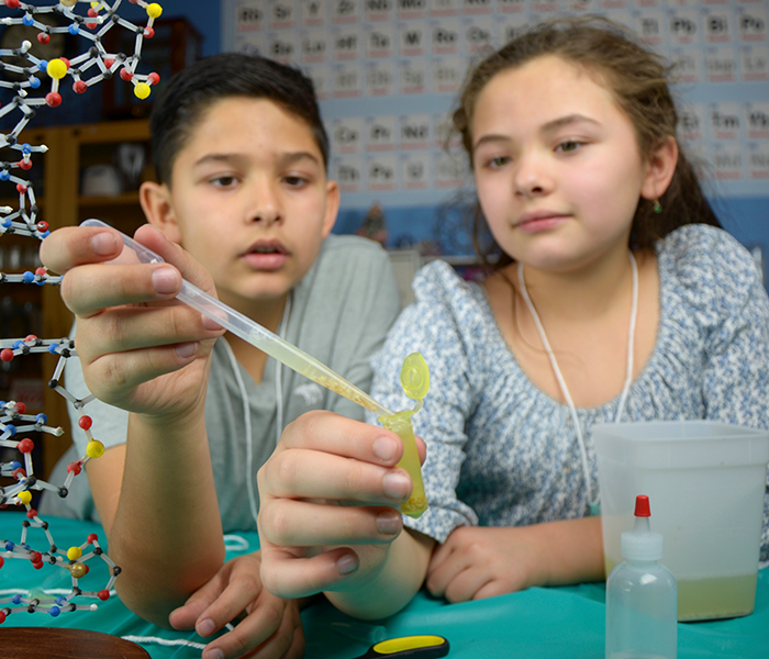 Children exploring Building with Biology DNA activity using pipette 