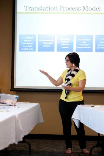 educator in yellow shirt giving a presentation