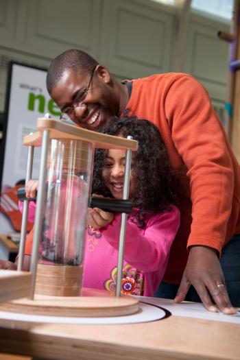 Father and child using the ferrofluid exhibit Small Smaller Nano exhibition the Nano exhibition