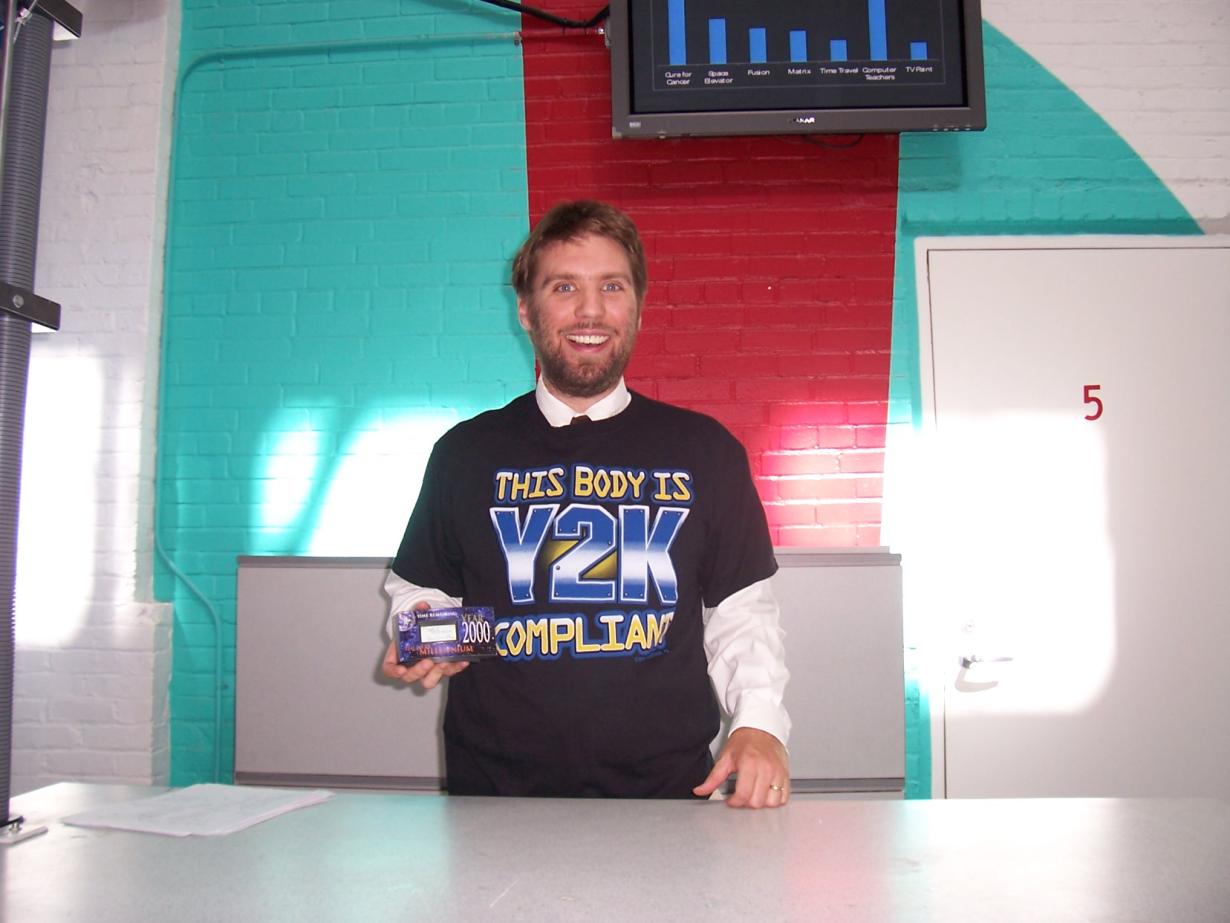 Facilitator in a black Y2K shirt introducing the presentation