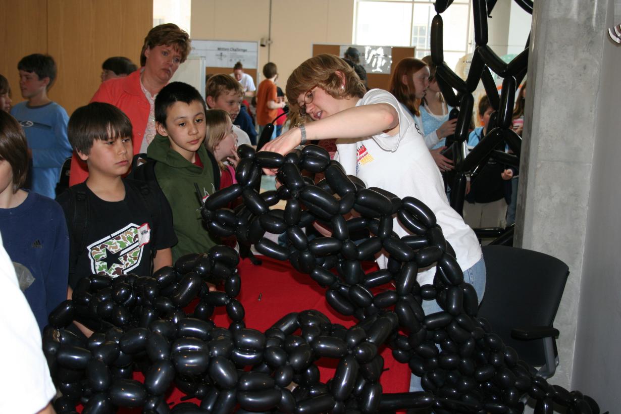 Group of students building a carbon nanotube model out of balloons