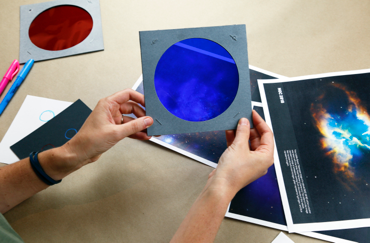 hands holding up colored filters in Filtered Light activity
