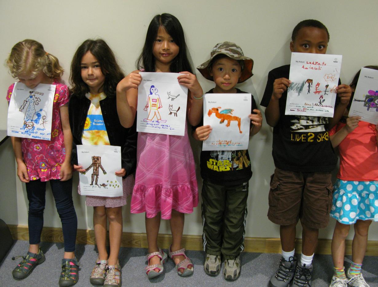 Learners holding image drawings of robots 