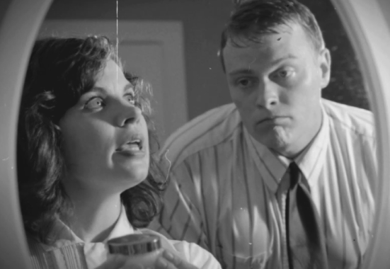 Two actors looking into a mirror having a conversation