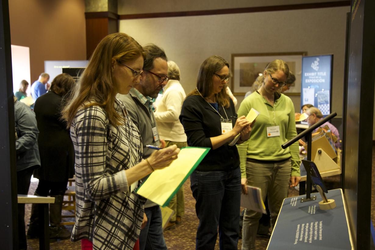 Group of people with clipboards writing 