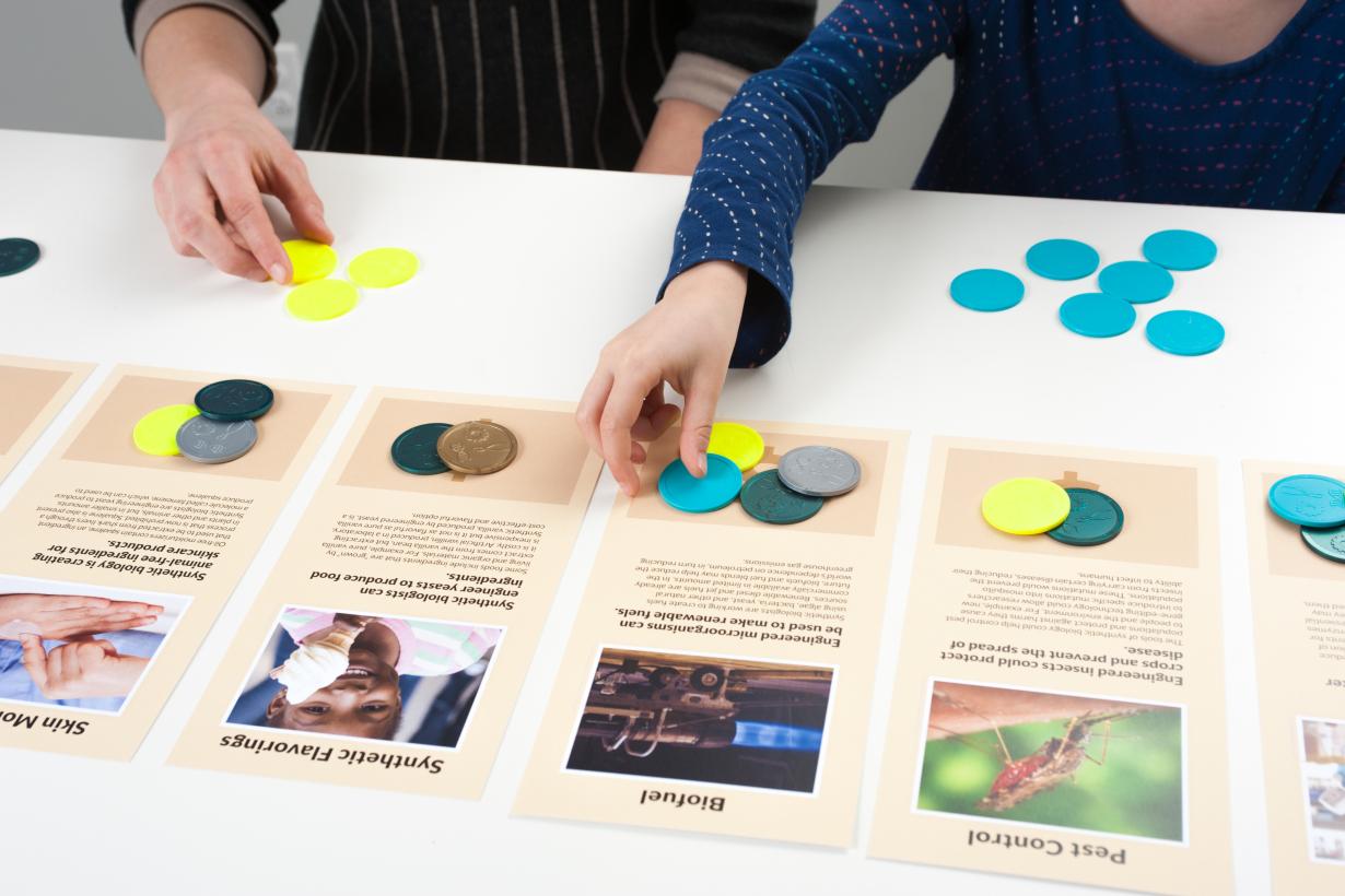 Hands sorting tokens to signify which technology is most important to them