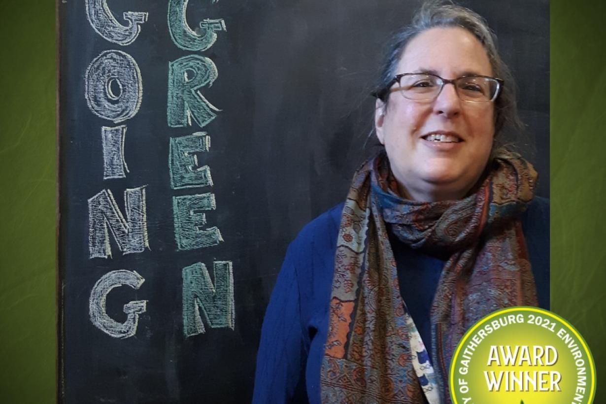 Photo of an Gaithersburg Museum educator accepting a going green award